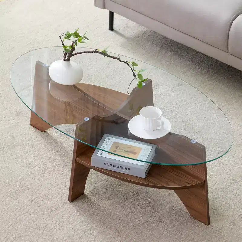 Runder Couchtisch aus Glas, ovaler Cocktailtisch, ovaler Mitteltisch, Akzenttisch, Sofatisch mit diagonal angeordnetem fächerförmigem Ablagebein, Walnuss/Natur